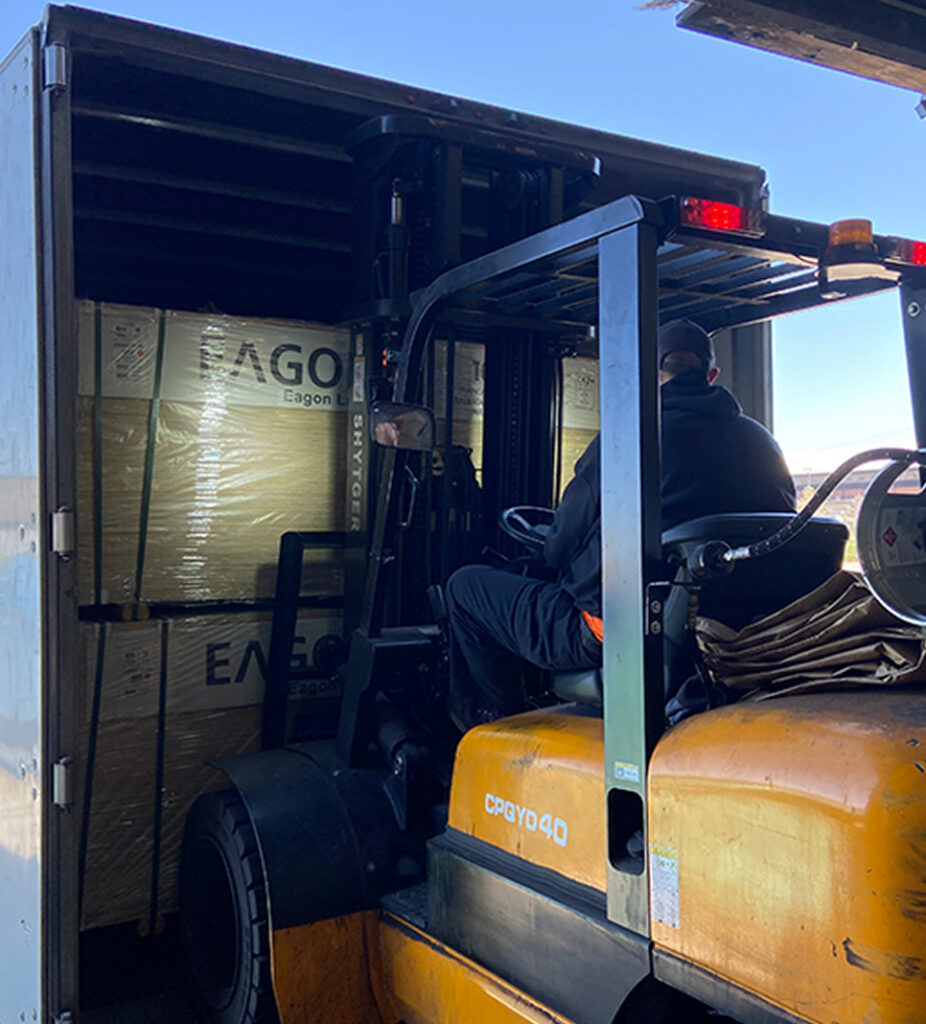 Forklift lifting Eagon wood out of truck