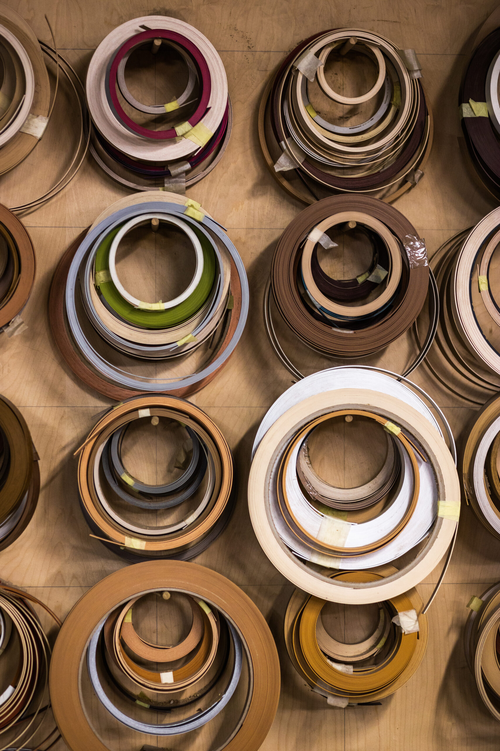 Rolls of plywood edge banding hanging on a wall