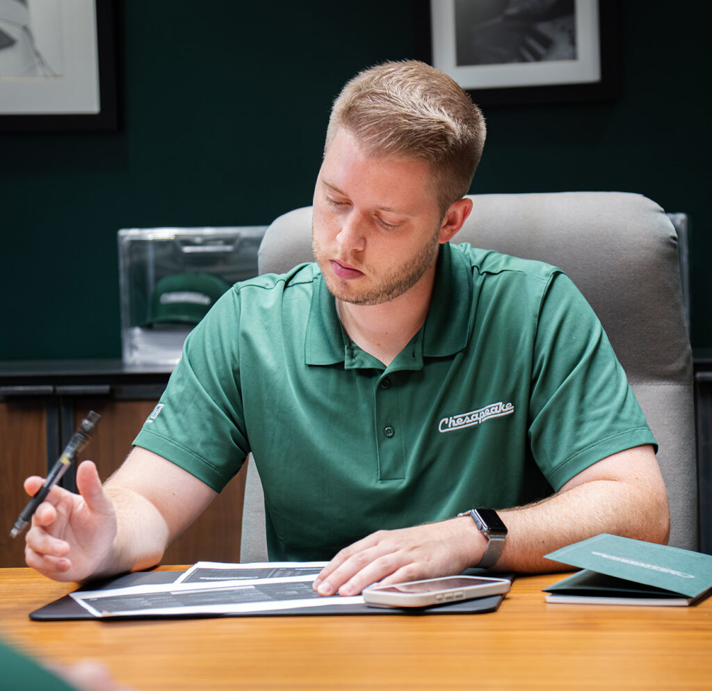 man focusing on document in conference room