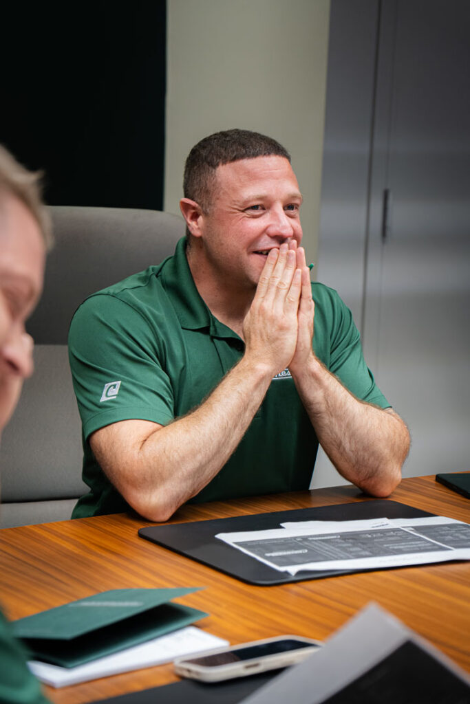 man laughing in chesapeake plywood conference room