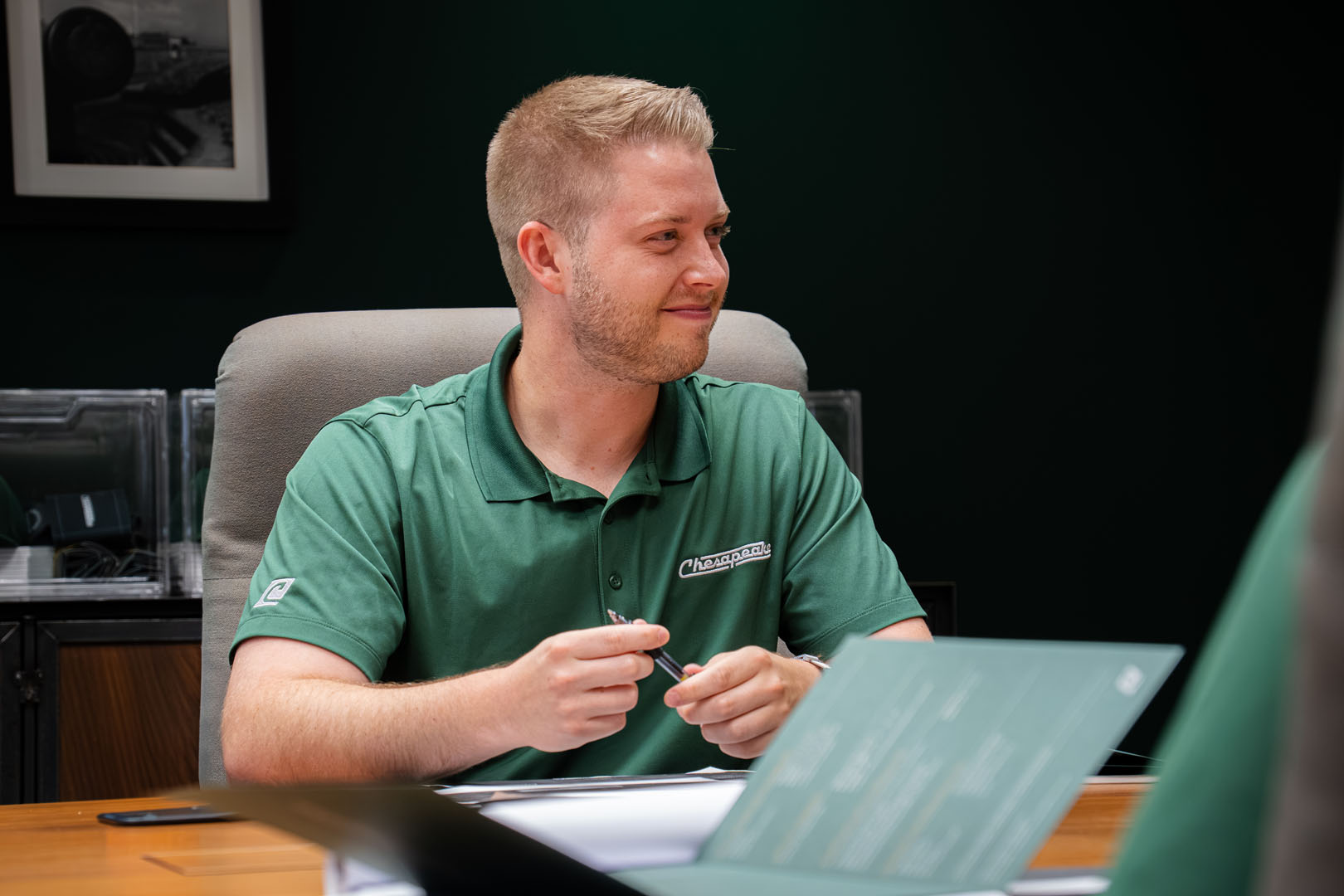man smiling in chespeake plywood conference room