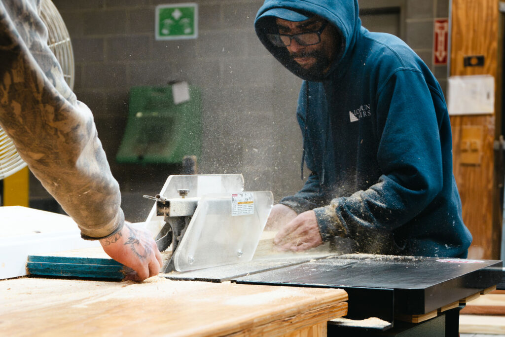 millworker processing wood panel