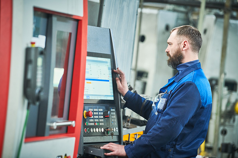 man operating cnc machine