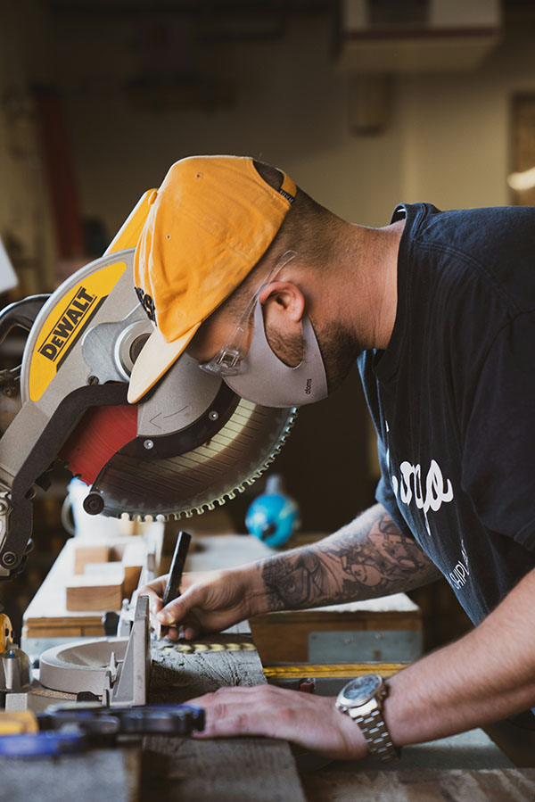 man working at wood saw