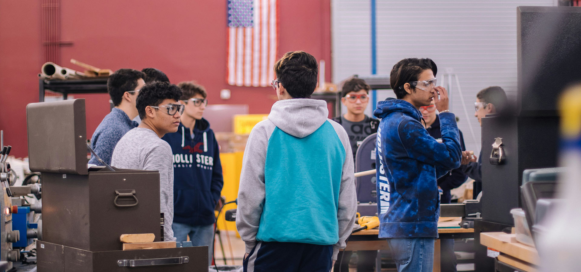 teenagers wearing eye protection during shop class – banner